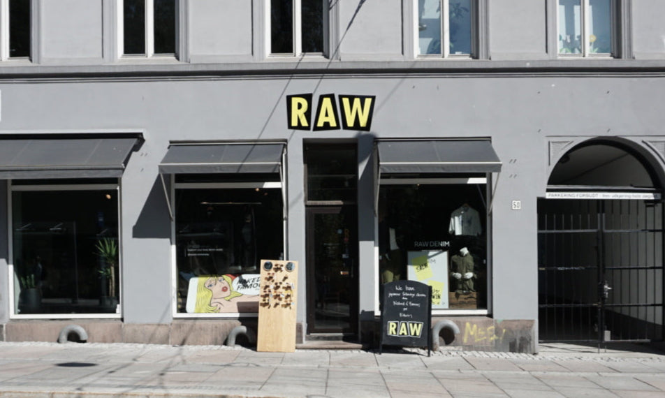 Storefront with 'RAW' sign on a building facade