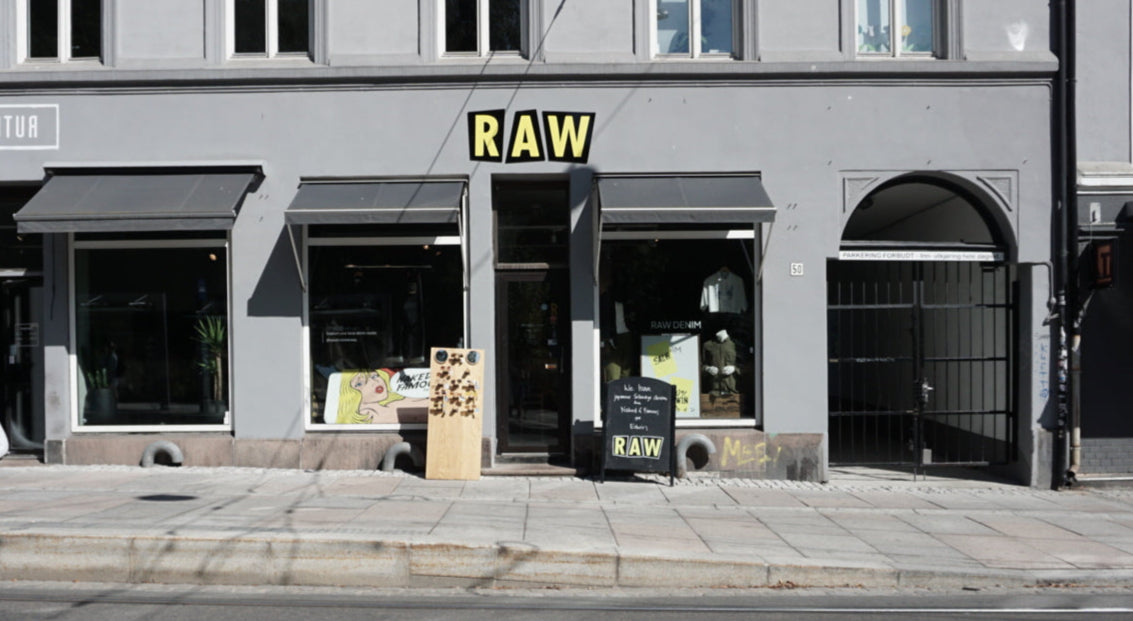 Gray building with 'RAW' sign on a street